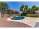 Lush backyard features a sparkling pool with a rock waterfall feature at 4102 E Palm Beach Dr, Chandler, AZ 85249