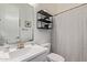 Modern bathroom features sleek fixtures, black shelving, and a stylish shower curtain at 4442 E Fairbrook St, Mesa, AZ 85205