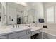 Clean, bright bathroom with double vanity, tub, and walk-in shower with glass door at 4442 E Fairbrook St, Mesa, AZ 85205