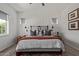 Cozy bedroom with accent wall, ceiling fan, patterned rug, and lots of natural light at 4442 E Fairbrook St, Mesa, AZ 85205