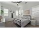 Cozy bedroom with a ceiling fan, large windows with shutters, and a comfortable bed at 4442 E Fairbrook St, Mesa, AZ 85205