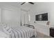Bright bedroom featuring a ceiling fan, sliding closet doors, and a large dresser at 4442 E Fairbrook St, Mesa, AZ 85205