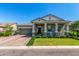 Charming home exterior featuring a covered porch, landscaped yard and brick driveway at 4442 E Fairbrook St, Mesa, AZ 85205