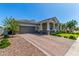 Beautiful home featuring a brick driveway, desert landscaping, and charming architectural details at 4442 E Fairbrook St, Mesa, AZ 85205