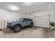 Spacious garage with a modern car parked inside and ample space for storage at 4442 E Fairbrook St, Mesa, AZ 85205