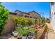 Enjoy fresh produce in this beautiful garden plot, framed by a stucco wall at 4442 E Fairbrook St, Mesa, AZ 85205