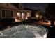 Luxurious hot tub on a patio, backyard with outdoor lighting, and manicured lawn at 4442 E Fairbrook St, Mesa, AZ 85205