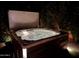 Inviting hot tub with illuminated jets, set amidst lush greenery in a private backyard at 4442 E Fairbrook St, Mesa, AZ 85205