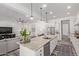 Modern kitchen featuring a large island with a sink, white cabinetry, and stainless steel appliances at 4442 E Fairbrook St, Mesa, AZ 85205