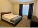Inviting bedroom features a plush bed with stylish linens, cozy carpeting, and modern decor at 4601 N 102Nd Ave # 1052, Phoenix, AZ 85037
