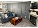 Cozy living room features a gray sofa, wooden coffee table, and decorative board and batten wall at 4601 N 102Nd Ave # 1052, Phoenix, AZ 85037