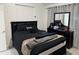 This bedroom features an all-black comforter set and a dresser with a mirror for prepping for your day or night out at 4601 N 102Nd Ave # 1194, Phoenix, AZ 85037