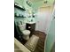 Bathroom with modern toilet, dark wood cabinets, dark wood floors and light green walls at 4767 W Wahalla Ln, Glendale, AZ 85308