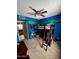 Bedroom with carpet, a bright blue accent wall, and a ladder-style bunkbed with a desk underneath at 4767 W Wahalla Ln, Glendale, AZ 85308