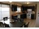 Eat-in kitchen featuring modern appliances, dark cabinetry and bright natural light at 4767 W Wahalla Ln, Glendale, AZ 85308