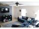 Bright and airy living room with comfortable seating, ceiling fan and TV at 4767 W Wahalla Ln, Glendale, AZ 85308