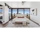 Brightly lit bedroom with large windows, ceiling fan, modern art, and a comfortable bed at 4808 N 24Th St # 1228, Phoenix, AZ 85016