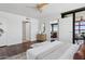 Bedroom with wood floors, ceiling fan, adjacent bathroom, and a seating area at 4808 N 24Th St # 1228, Phoenix, AZ 85016