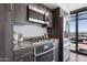 Modern kitchen featuring granite countertops, stainless appliances, and contemporary dark wood cabinets at 4808 N 24Th St # 1228, Phoenix, AZ 85016