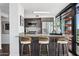 Modern kitchen featuring a granite counter bar, stainless steel appliances, and stylish bar stools at 4808 N 24Th St # 1228, Phoenix, AZ 85016