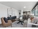 Modern open-concept living space with sleek dark wood floors and stylish decor accents at 4808 N 24Th St # 1228, Phoenix, AZ 85016