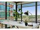 Bright home office featuring a modern desk, stylish lamp, and expansive windows with city views at 4808 N 24Th St # 1228, Phoenix, AZ 85016