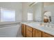 Well-lit bathroom features double sinks and a large bathtub at 4928 E Paradise Ln, Scottsdale, AZ 85254