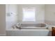 Corner bathtub has tile backsplash and lots of room at 4928 E Paradise Ln, Scottsdale, AZ 85254