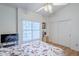 Bedroom with wood floors, large window, closet and ceiling fan at 4928 E Paradise Ln, Scottsdale, AZ 85254