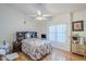 Comfortable bedroom with a ceiling fan, wood-look flooring, and a large window at 4928 E Paradise Ln, Scottsdale, AZ 85254