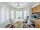 Cozy breakfast nook with large windows, a ceiling fan, and built-in desk area at 4928 E Paradise Ln, Scottsdale, AZ 85254
