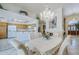 Open-concept dining area with a crystal chandelier, fireplace, and seamless access to the kitchen at 4928 E Paradise Ln, Scottsdale, AZ 85254