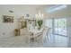 Formal dining room features modern light fixture and outdoor access at 4928 E Paradise Ln, Scottsdale, AZ 85254