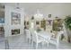Bright dining room featuring white furnishings, tiled floors, chandelier, and decorative fireplace with large wall art at 4928 E Paradise Ln, Scottsdale, AZ 85254