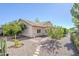 Charming single-story home with well-manicured landscaping, mature trees, and a stone pathway leading to the entrance at 4928 E Paradise Ln, Scottsdale, AZ 85254