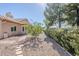Charming exterior of a well-maintained home with gravel landscaping, mature trees, and a brick walkway at 4928 E Paradise Ln, Scottsdale, AZ 85254