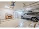 Spacious garage with car, desk, cabinets, epoxy floor, and ceiling fans provide ample space for storage and projects at 4928 E Paradise Ln, Scottsdale, AZ 85254