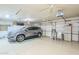 Epoxy floor spacious garage featuring modern doors, cabinets, and plenty of room for vehicle storage and household projects at 4928 E Paradise Ln, Scottsdale, AZ 85254