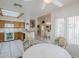 Bright kitchen featuring tile flooring, a skylight, and views into the dining area at 4928 E Paradise Ln, Scottsdale, AZ 85254