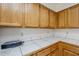 Kitchen details featuring wood cabinets, tile countertops, and electrical outlets along the backsplash at 4928 E Paradise Ln, Scottsdale, AZ 85254
