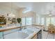 Kitchen with a breakfast bar that opens to a dining area, enhanced by a skylight and ample natural light at 4928 E Paradise Ln, Scottsdale, AZ 85254