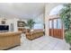 Open-concept living room showcases tile flooring, an arched window, and an inviting, decorative living space at 4928 E Paradise Ln, Scottsdale, AZ 85254