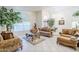 Spacious living room with tile floors, high ceilings, and traditional furniture and decor at 4928 E Paradise Ln, Scottsdale, AZ 85254