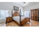 Spacious main bedroom features a wood-look floor and ceiling fan at 4928 E Paradise Ln, Scottsdale, AZ 85254