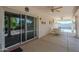 Covered patio with seating area, ceiling fans, and a view of the pool through sliding glass doors at 4928 E Paradise Ln, Scottsdale, AZ 85254