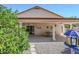 Covered patio features a dining set, ceiling fans, and a peaceful view of the landscaped backyard and mature trees at 4928 E Paradise Ln, Scottsdale, AZ 85254