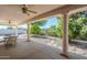 Inviting covered patio offers a relaxing space with views of the manicured backyard and sparkling pool at 4928 E Paradise Ln, Scottsdale, AZ 85254