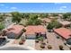 Aerial view showcasing a beautiful home with a red tile roof, lush landscaping, and a circular driveway at 5024 S Citrus Ct, Gilbert, AZ 85298