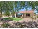 Picturesque backyard featuring a covered patio, artificial grass, and desert landscaping at 5024 S Citrus Ct, Gilbert, AZ 85298