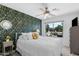 Bedroom showcases a floral accent wall, ceiling fan, and bright window view at 5024 S Citrus Ct, Gilbert, AZ 85298
